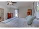 Bright bedroom featuring a ceiling fan, dresser, a cozy queen bed, and natural light through the window at 834 Holly Sands Blvd., Little River, SC 29566