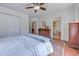 This bedroom features hardwood floors, a ceiling fan, a closet, and direct access to an attached bathroom at 834 Holly Sands Blvd., Little River, SC 29566