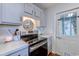 Bright kitchen with updated stainless steel appliances, light countertops, and an exterior door for easy outdoor access at 834 Holly Sands Blvd., Little River, SC 29566