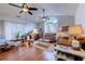Bright and airy living room with hardwood flooring, ceiling fans, large window, and comfortable seating arrangements at 834 Holly Sands Blvd., Little River, SC 29566