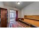 A spacious living room with hardwood floors, a modern cabinet, and sliding doors that open to a sunroom at 834 Holly Sands Blvd., Little River, SC 29566