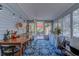 Bright sun room with a colorful rug, seating and an exit to the back yard at 834 Holly Sands Blvd., Little River, SC 29566