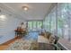 Bright sun room with a colorful rug, seating and lots of natural light at 834 Holly Sands Blvd., Little River, SC 29566