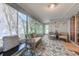 Bright sun room featuring comfortable seating and multiple windows at 834 Holly Sands Blvd., Little River, SC 29566