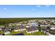 Aerial view of townhomes around a pond, lush trees, and blue sky in South Bay Lakes at 8835 Chandler Dr. # E, Myrtle Beach, SC 29575