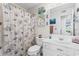 Bathroom featuring a vanity, toilet, mirror, and shower with seashell patterned curtain at 8835 Chandler Dr. # E, Myrtle Beach, SC 29575