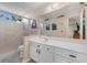 Well-lit bathroom featuring a sleek white vanity, framed mirror, and a walk-in shower with grab bar at 8835 Chandler Dr. # E, Myrtle Beach, SC 29575
