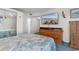 Comfortable bedroom with a large dresser, mirror closet doors, and a beach-themed wall-mounted television at 8835 Chandler Dr. # E, Myrtle Beach, SC 29575