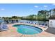 Community pool and lounge area with views of the lake at 8835 Chandler Dr. # E, Myrtle Beach, SC 29575