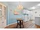 Charming dining area adjacent to the kitchen, featuring a stylish chandelier and coastal decor at 8835 Chandler Dr. # E, Myrtle Beach, SC 29575
