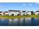 Back exterior view of the home overlooking a pond on a bright day at 8835 Chandler Dr. # E, Myrtle Beach, SC 29575