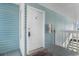 Entrance to the condo showcasing the front door, unit number, and blue siding at 8835 Chandler Dr. # E, Myrtle Beach, SC 29575
