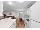 Bright kitchen with white appliances that overlooks the living and dining areas at 8835 Chandler Dr. # E, Myrtle Beach, SC 29575