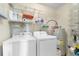 Laundry room featuring a washer, dryer, water heater, and storage shelves at 8835 Chandler Dr. # E, Myrtle Beach, SC 29575
