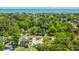 A lush residential area near the ocean, boasting tree-lined streets and a variety of homes under a vast, clear sky at 1021 Myrtle Dr., Surfside Beach, SC 29575