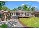 Expansive backyard featuring a hot tub, deck, gazebo, and lush green lawn, creating a perfect outdoor oasis at 1021 Myrtle Dr., Surfside Beach, SC 29575