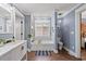 A stunning bathroom is equipped with a soaking tub, statement lighting and white vanity at 1021 Myrtle Dr., Surfside Beach, SC 29575