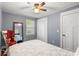 A serene bedroom featuring a ceiling fan, natural light, and wood-look flooring at 1021 Myrtle Dr., Surfside Beach, SC 29575
