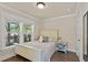 A cozy bedroom featuring warm natural light, neutral paint, and wood-look flooring at 1021 Myrtle Dr., Surfside Beach, SC 29575