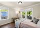 A bright bedroom featuring a writing desk, wood-look flooring, and a balcony at 1021 Myrtle Dr., Surfside Beach, SC 29575