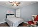 A cozy bedroom featuring light blue walls, white trim, and a ceiling fan at 1021 Myrtle Dr., Surfside Beach, SC 29575