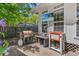 Outdoor kitchen area featuring a grill, prep station, and mounted television for a complete entertainment experience at 1021 Myrtle Dr., Surfside Beach, SC 29575
