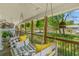Inviting front porch with a porch swing and overhead fan, offering a relaxing outdoor space with a scenic view at 1021 Myrtle Dr., Surfside Beach, SC 29575