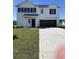 A charming two-story white home with black shutters, inviting front door, and an attached garage at 1028 Kinness Dr., Conway, SC 29527