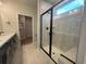 Modern bathroom featuring a walk-in shower with black trim and double sinks at 1213 Lady Bird Way, North Myrtle Beach, SC 29582