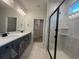 New bathroom featuring a walk-in shower with black trim and double sinks at 1213 Lady Bird Way, North Myrtle Beach, SC 29582
