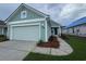 Charming single-Gathering home with attached garage, manicured lawn, and a welcoming entrance at 1213 Lady Bird Way, North Myrtle Beach, SC 29582