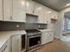 New kitchen featuring stainless steel appliances, white cabinets, and a stylish backsplash at 1213 Lady Bird Way, North Myrtle Beach, SC 29582
