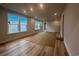 Bright living room features hardwood floors, recessed lighting, and large windows at 1213 Lady Bird Way, North Myrtle Beach, SC 29582