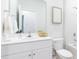 Bright bathroom features a pristine white vanity, toilet, and tub with modern fixtures at 215 Warner Crossing Way, Loris, SC 29569