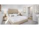 Elegant bedroom with a tufted headboard, neutral color scheme, and decorative bedside tables at 215 Warner Crossing Way, Loris, SC 29569