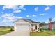 Charming single-story home with a well-manicured lawn and attached two-car garage at 215 Warner Crossing Way, Loris, SC 29569