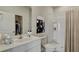 Bright bathroom with shower, white vanity, and modern artwork at 216 Warner Crossing Way, Loris, SC 29569