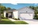 Charming one-story home featuring a two-car garage, stone accents, and a well-maintained lawn at 216 Warner Crossing Way, Loris, SC 29569