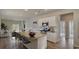 Open-concept kitchen includes granite countertops, stainless appliances, and a convenient island with barstool seating at 216 Warner Crossing Way, Loris, SC 29569