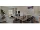 Bright, open living room features stylish furniture, modern decor, and a sliding glass door to the outdoor area at 216 Warner Crossing Way, Loris, SC 29569