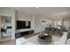Spacious living room with open layout, sleek entertainment center, and a view of the modern kitchen at 216 Warner Crossing Way, Loris, SC 29569