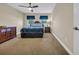 Cozy bedroom features plush carpeting, two windows with dark curtains, and a dark wooden dresser at 224 Je Edward Dr. # 17, Myrtle Beach, SC 29588