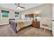 Bedroom featuring a large window with blinds, a bed with a wooden headboard and bedside tables at 224 Je Edward Dr. # 17, Myrtle Beach, SC 29588