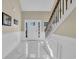 Bright foyer with marble tile floors, wainscoting, and a staircase with wood and iron railings at 224 Je Edward Dr. # 17, Myrtle Beach, SC 29588