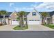 Charming townhome featuring a one-car garage, tidy landscaping, and a cozy front porch at 224 Je Edward Dr. # 17, Myrtle Beach, SC 29588