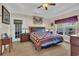 Bright and airy main bedroom suite showcasing tray ceilings, a ceiling fan and a decorative quilt at 224 Je Edward Dr. # 17, Myrtle Beach, SC 29588