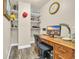 A home office features wood laminate flooring, open storage shelves, and a desk with computer at 224 Je Edward Dr. # 17, Myrtle Beach, SC 29588