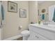 Neutral powder room with a white vanity, framed art, and coordinating fixtures at 224 Je Edward Dr. # 17, Myrtle Beach, SC 29588