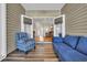 Inviting sunroom with a plush sofa and an armchair, and large doors leading to the outdoors at 224 Je Edward Dr. # 17, Myrtle Beach, SC 29588