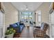 Bright sunroom with wood plank flooring, a comfortable sofa, and access to the outdoor space at 224 Je Edward Dr. # 17, Myrtle Beach, SC 29588